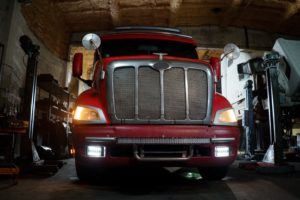 man inspecting semi truck